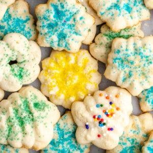 Overhead view of a pile of spritz cookies covered in different colors of sprinkles