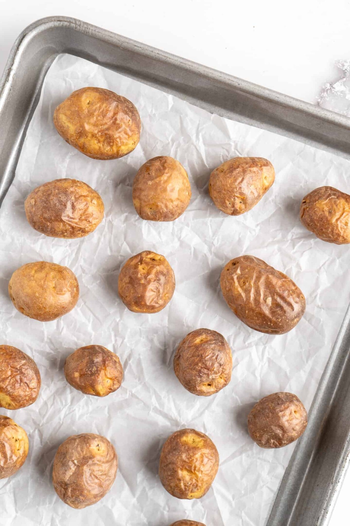 Cookied baby potatoes on a baking sheet