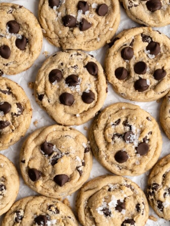 close up of Vegan chocolate chip cookies on parchment paper