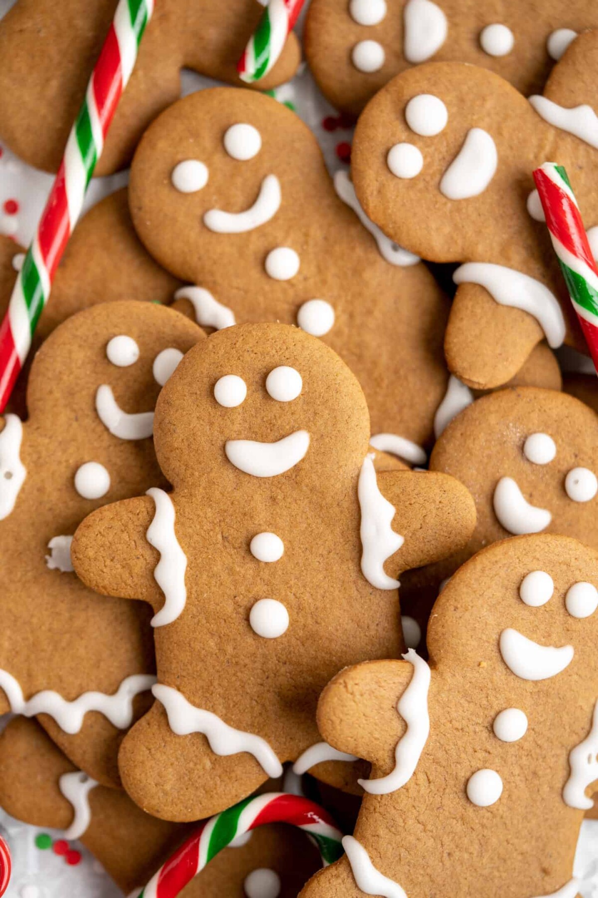 Close up of a pile of decorated gingerbread men with candycanes