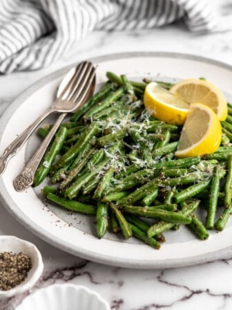 Air fryer green beans on plate with spoon and fork