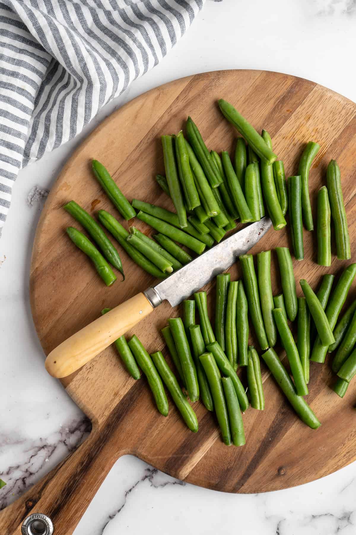 Green beans on cutting board with knife