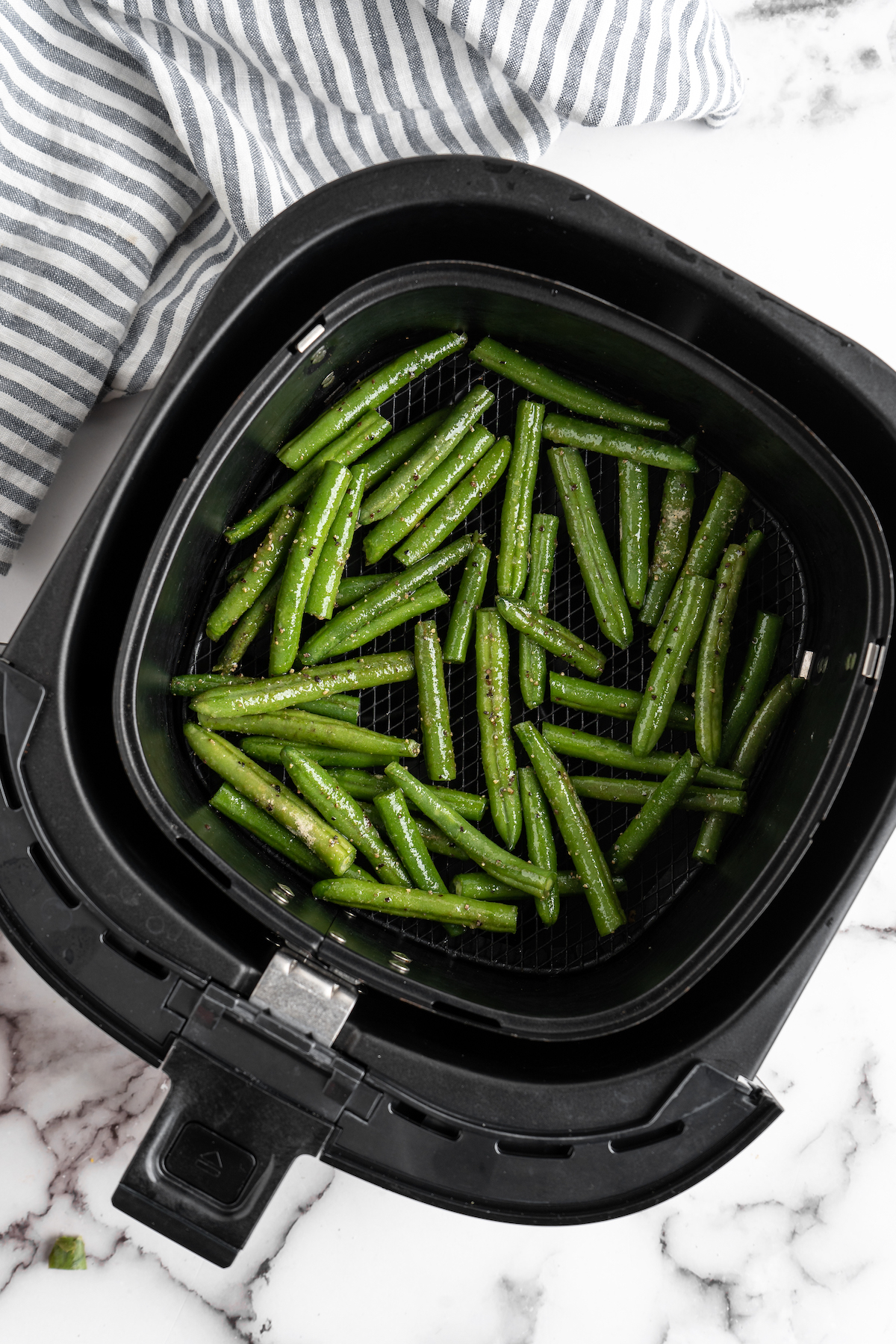 Green beans in air fryer basket