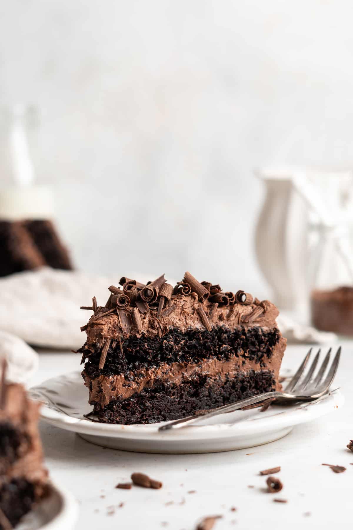 Slice of vegan chocolate cake on plate with fork