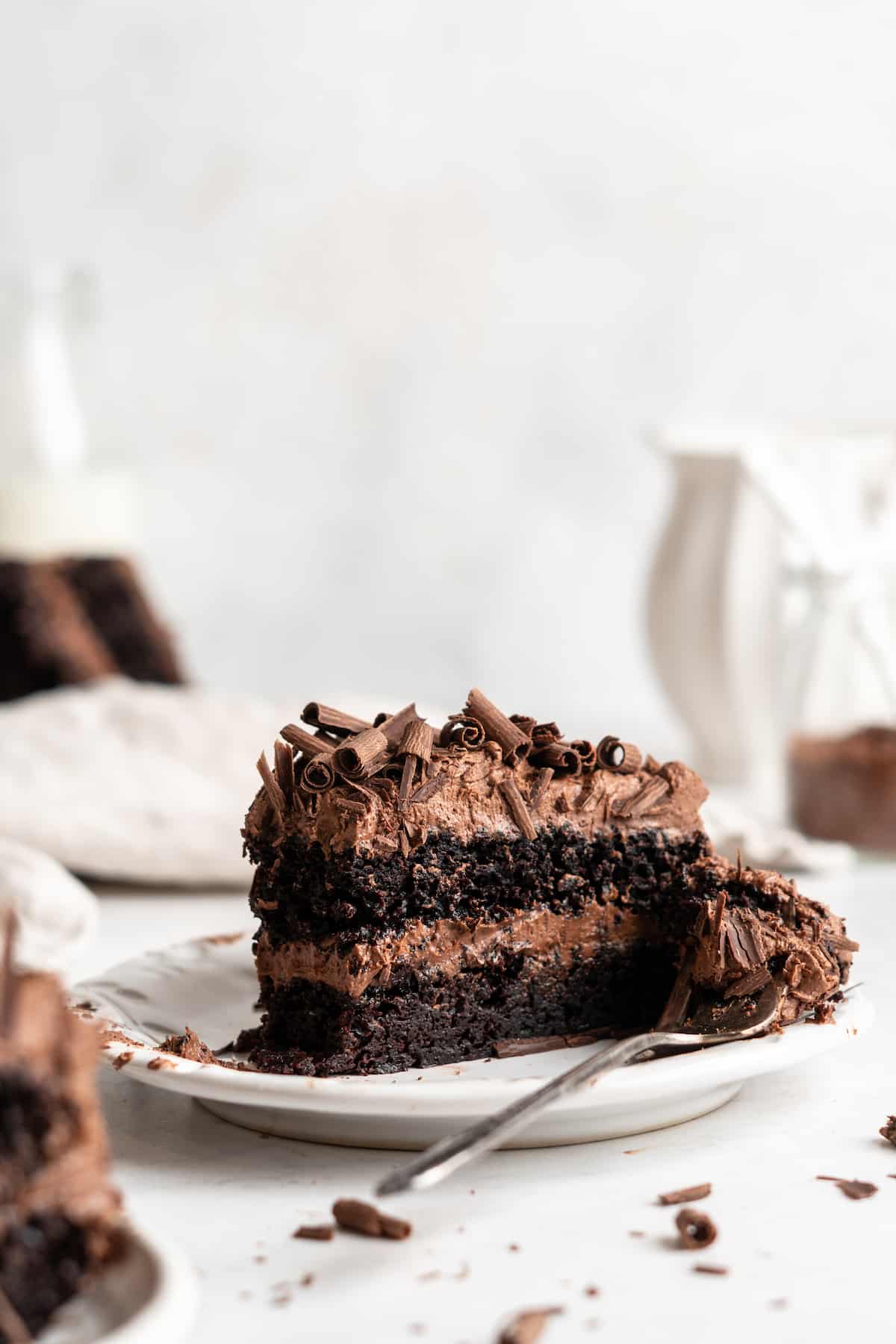 Two-layer vegan chocolate cake slice on plate