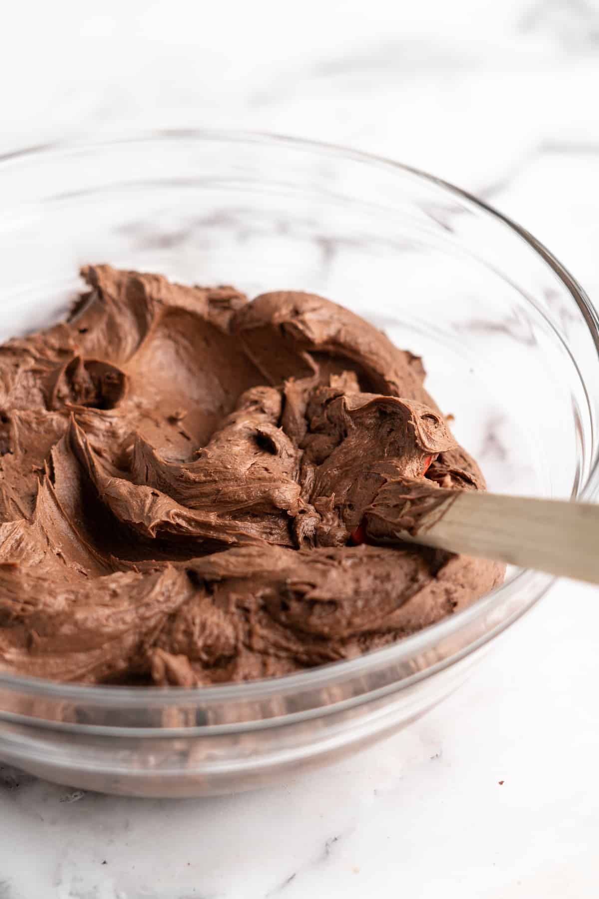 Vegan chocolate frosting in glass mixing bowl