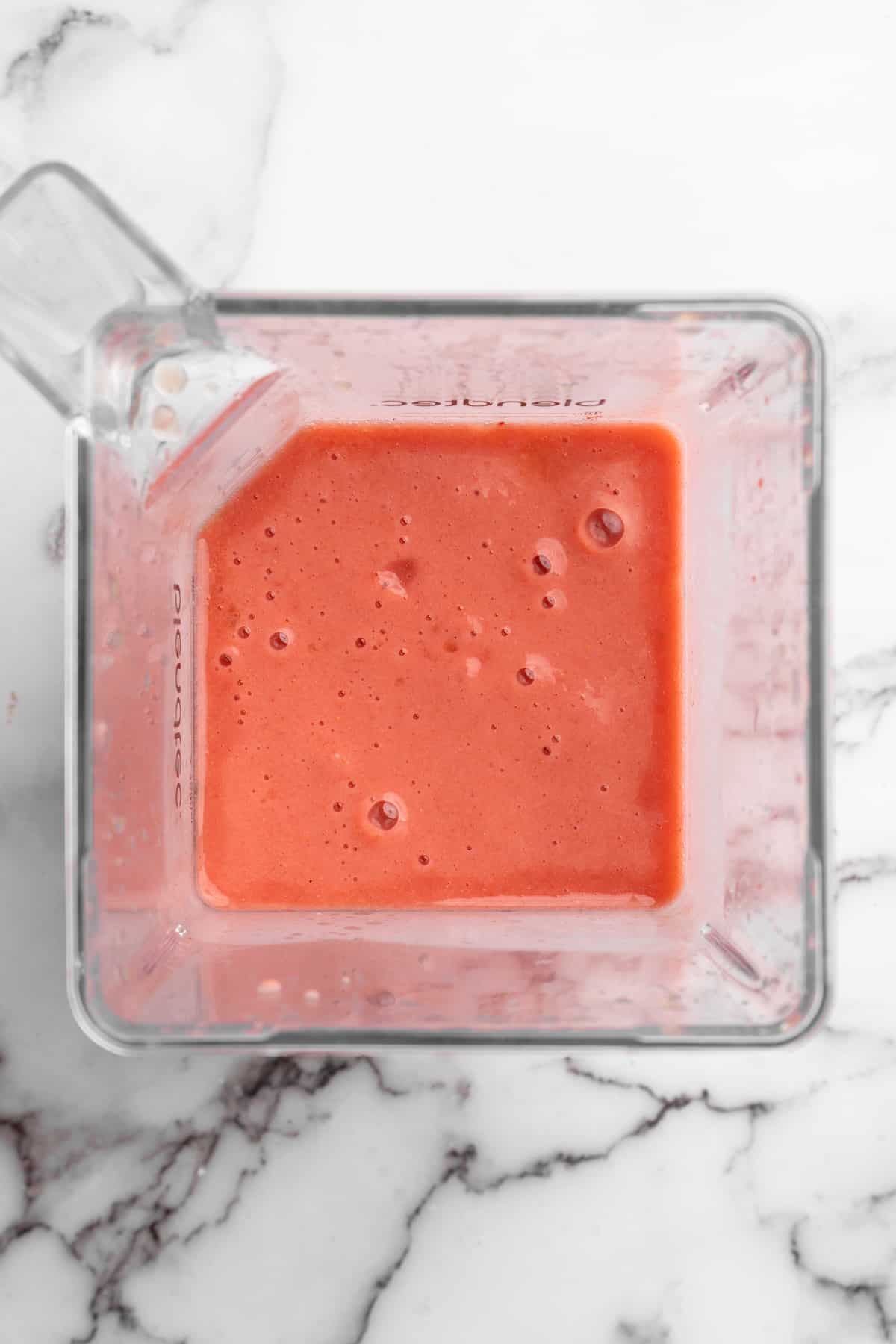 Overhead view of strawberry banana smoothie in blender