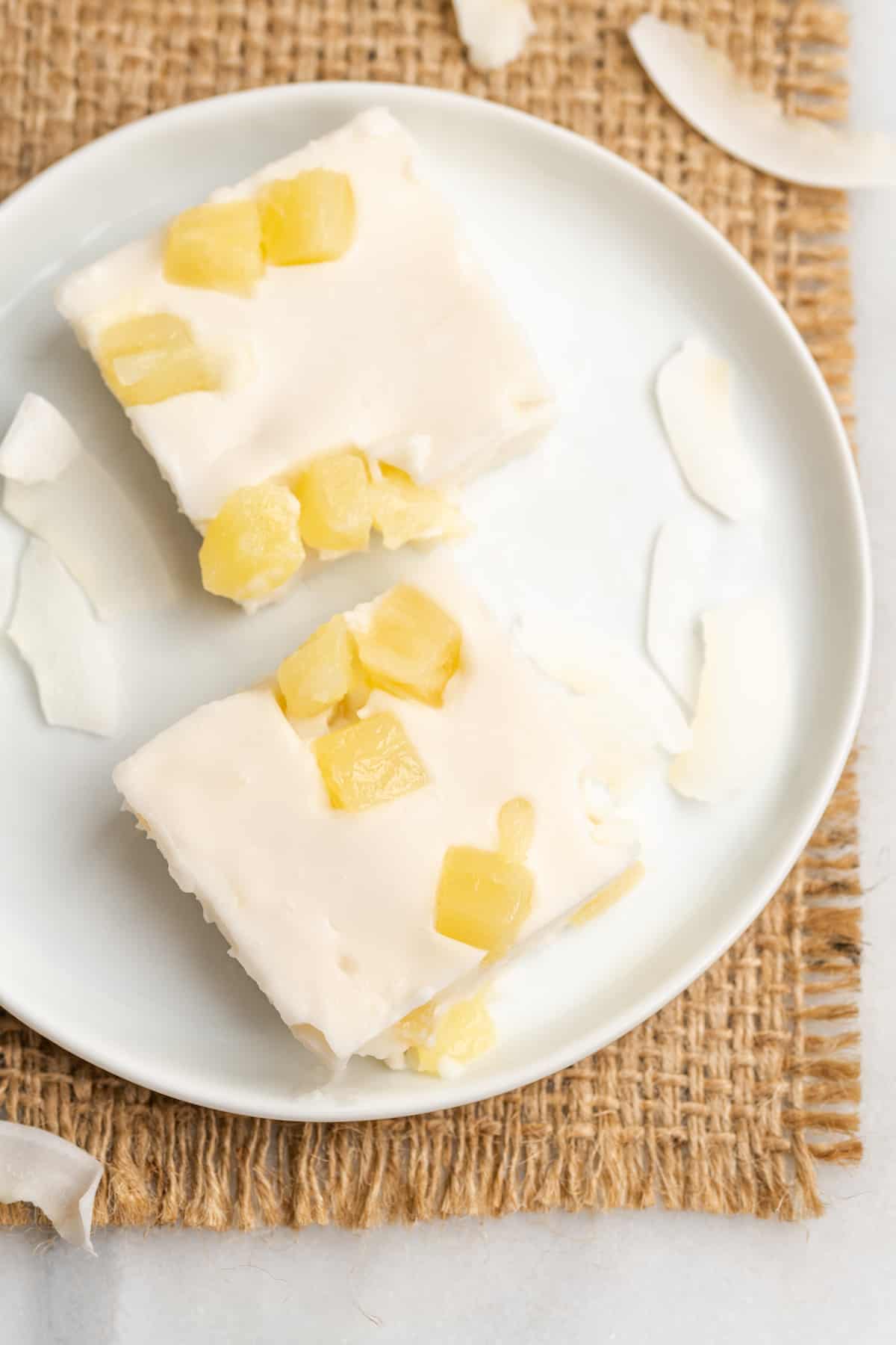 Two slices of pineapple haupia on white plate