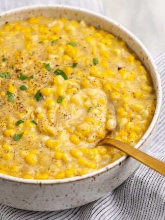 Vegan creamed corn in serving bowl with spoon