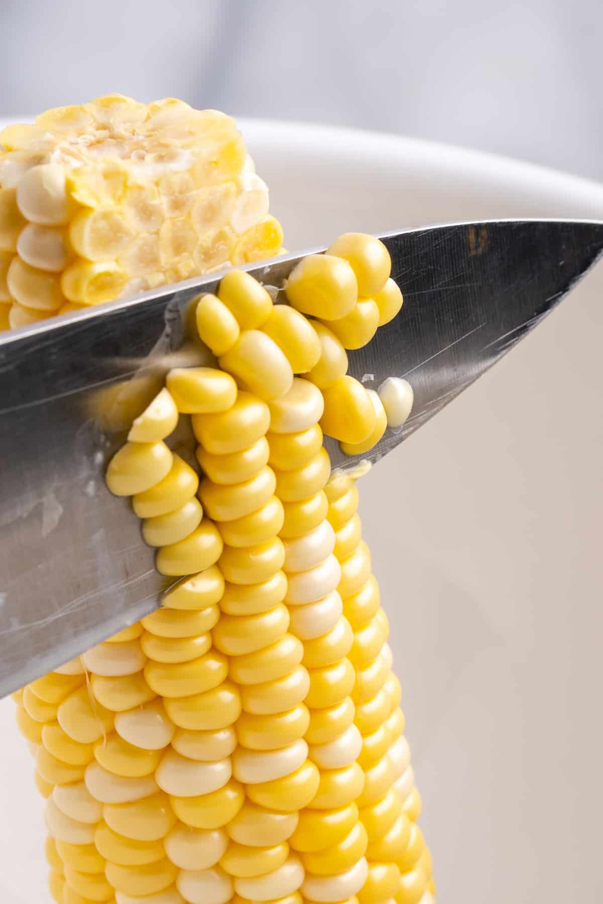 Knife cutting corn off cob