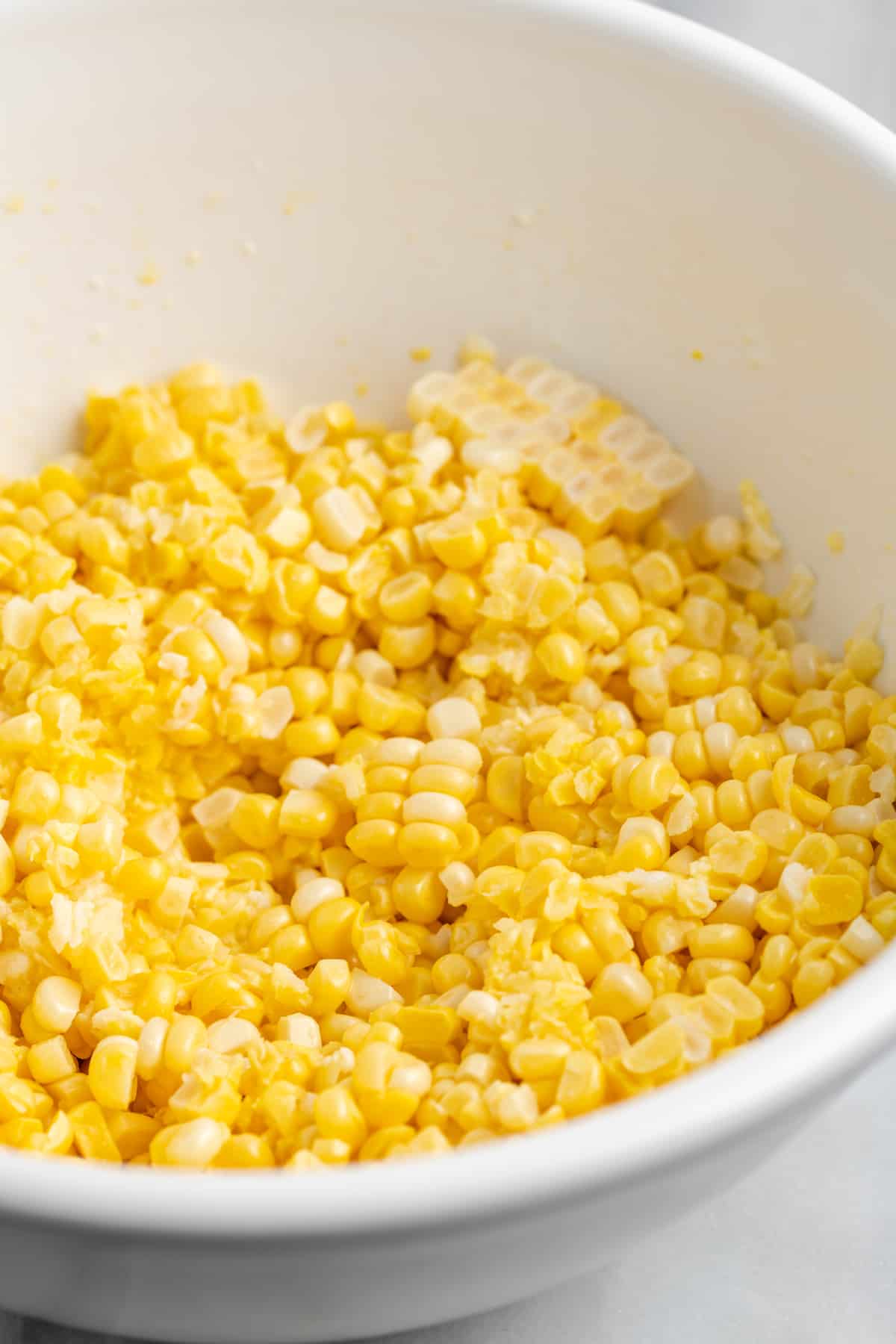 Fresh yellow corn in white bowl