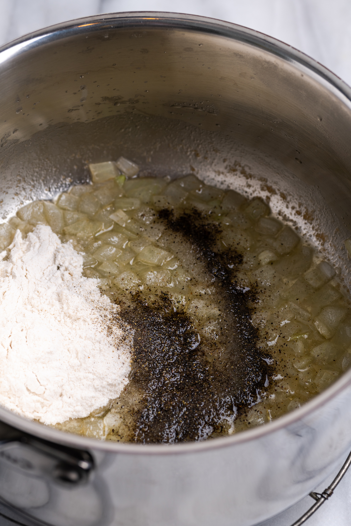 Flour and seasonings in pot with sauteed onions