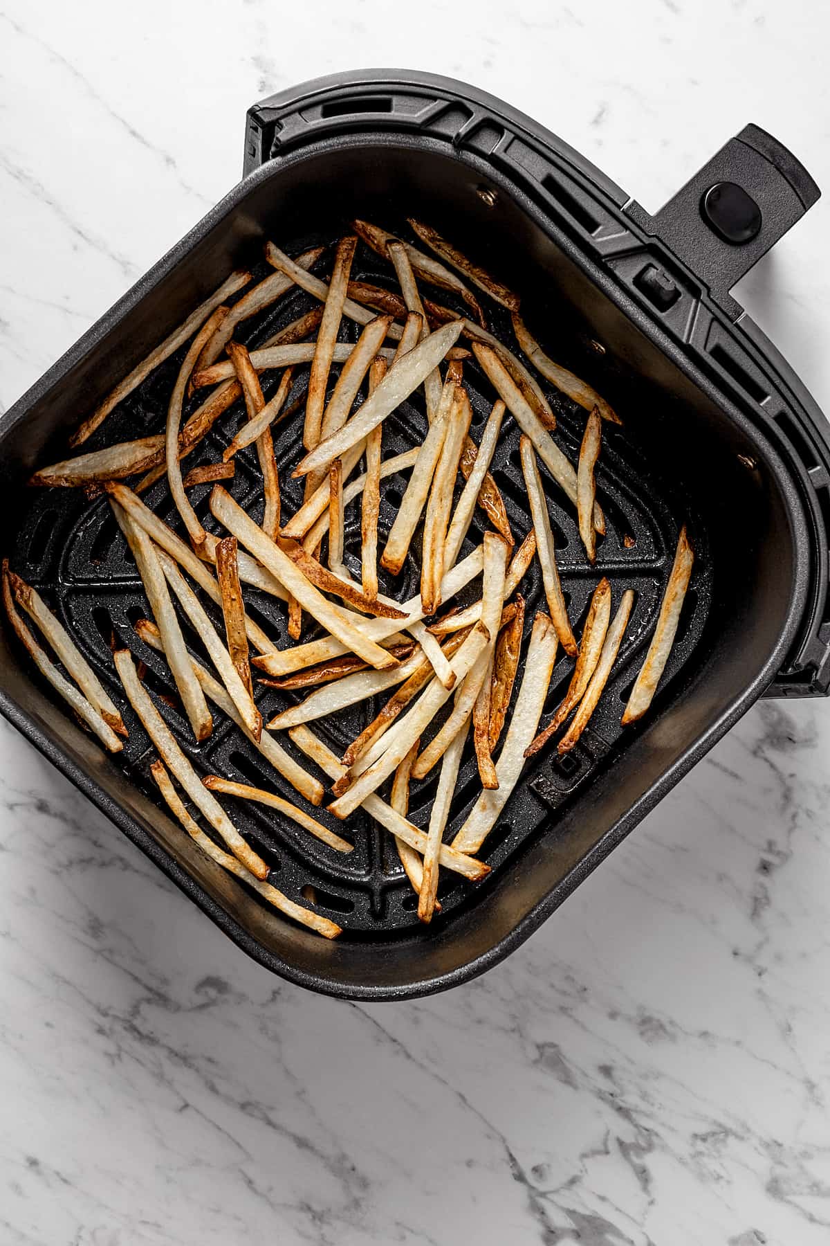 Overhead view of fries in air fryer basket