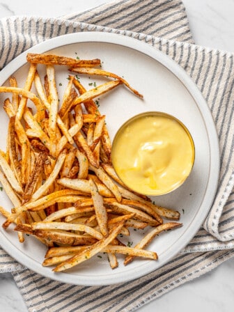 Overhead view of air fryer shoestring fries with dipping sauce