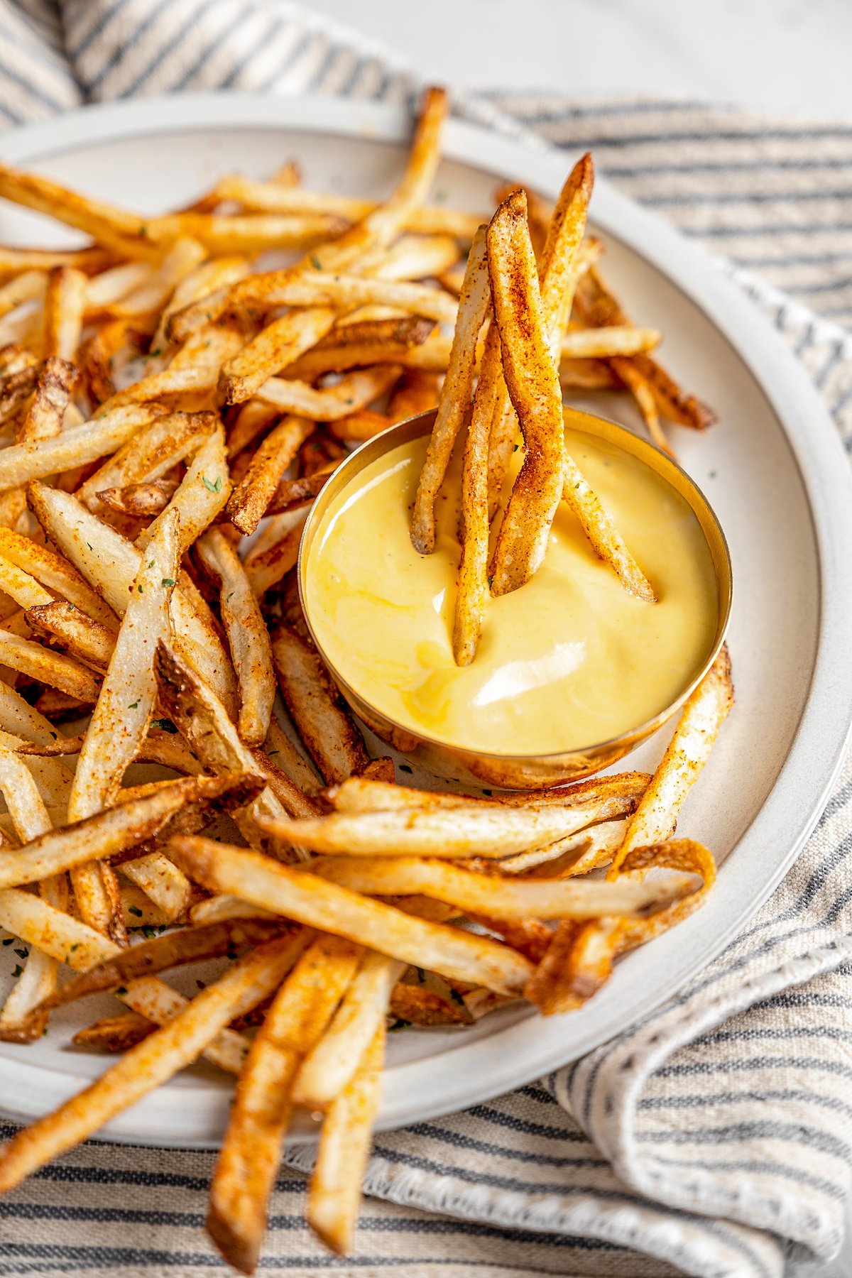 Plate of shoestring fries with dipping sauce
