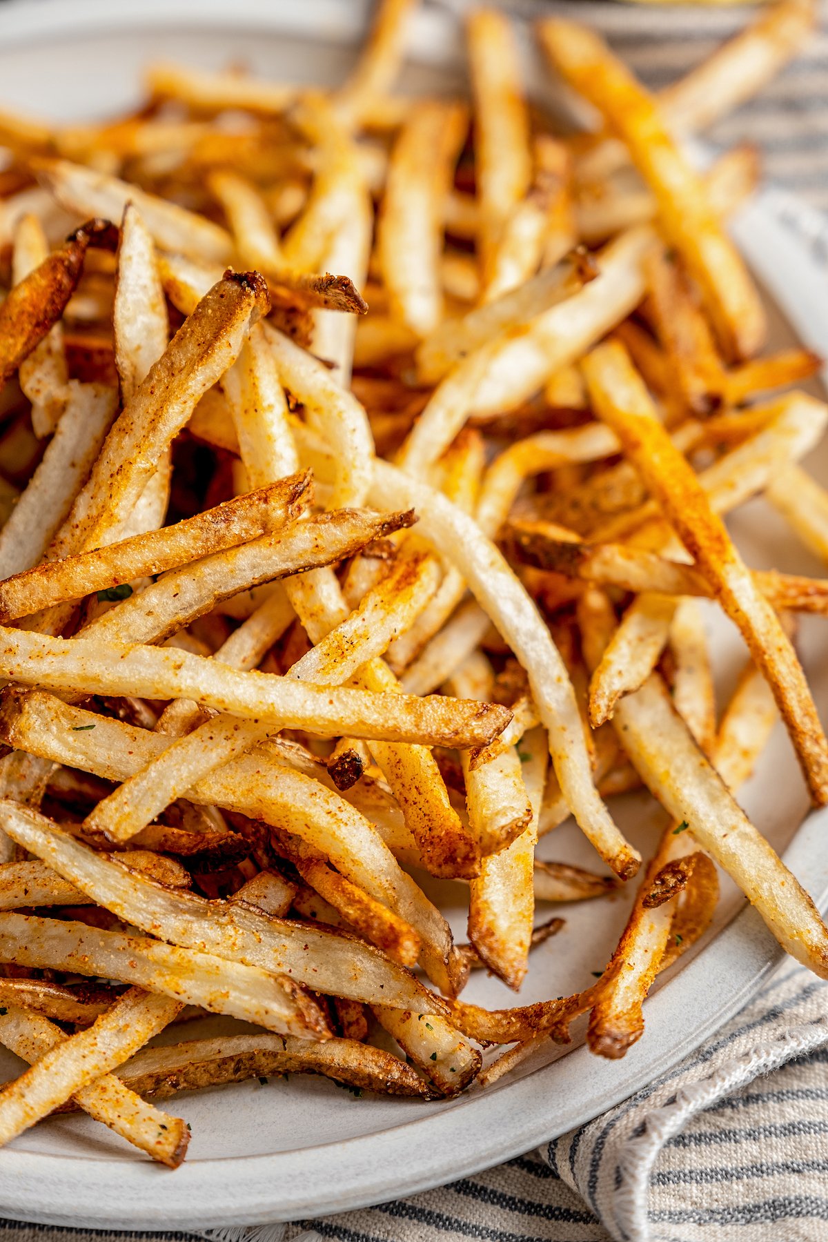 Shoestring fries piled on plate