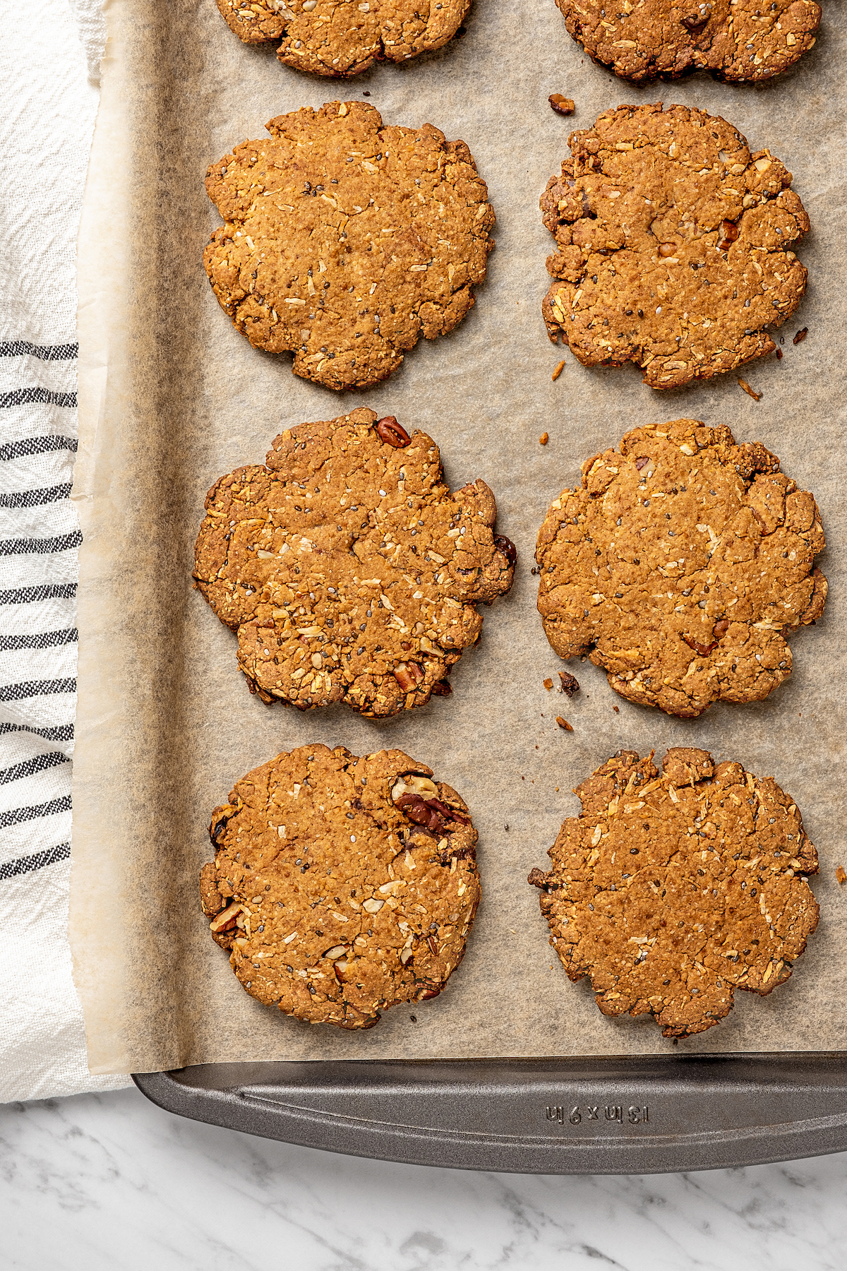 Overhead view of vegan lactation cookies on parchment lined baking sheet