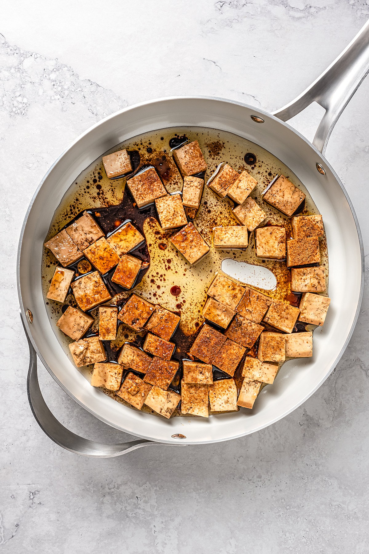Overhead view of tofu and sauce in skillet
