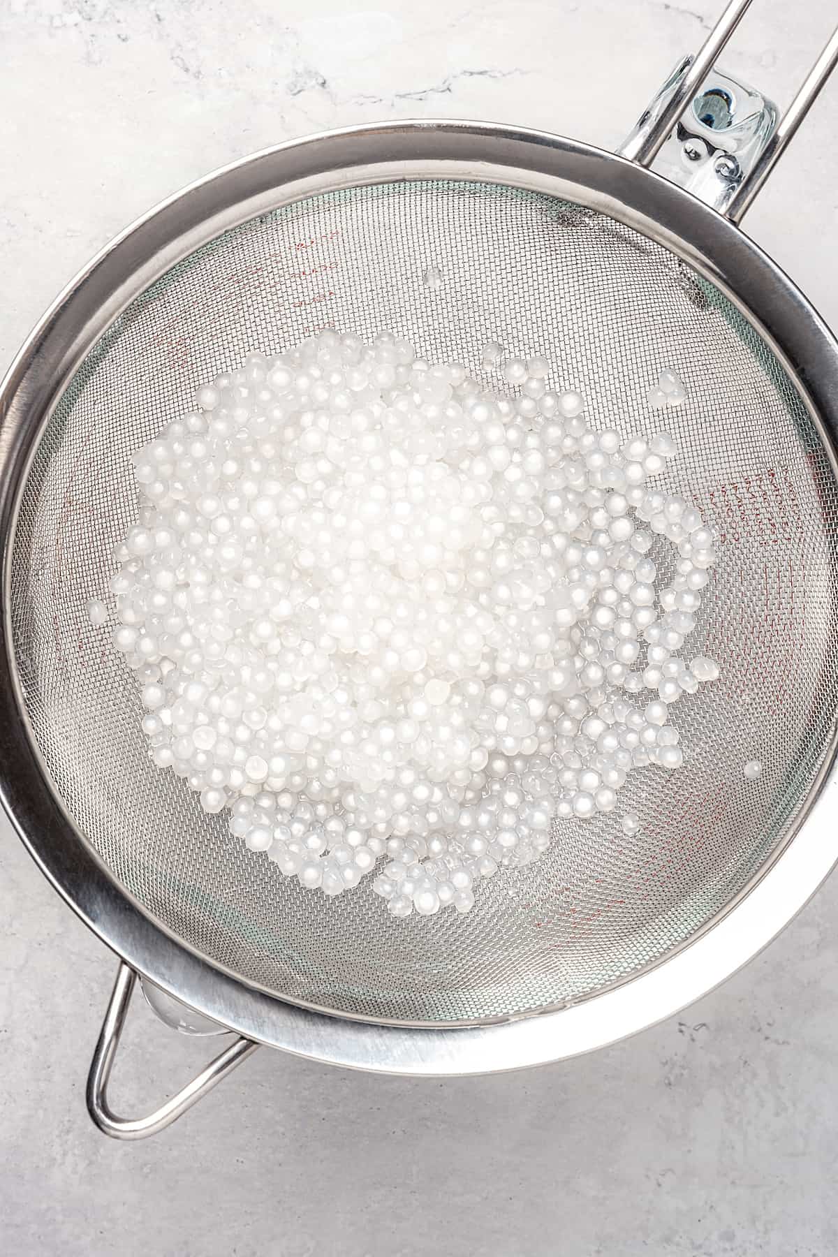 Sago pearls in fine mesh strainer