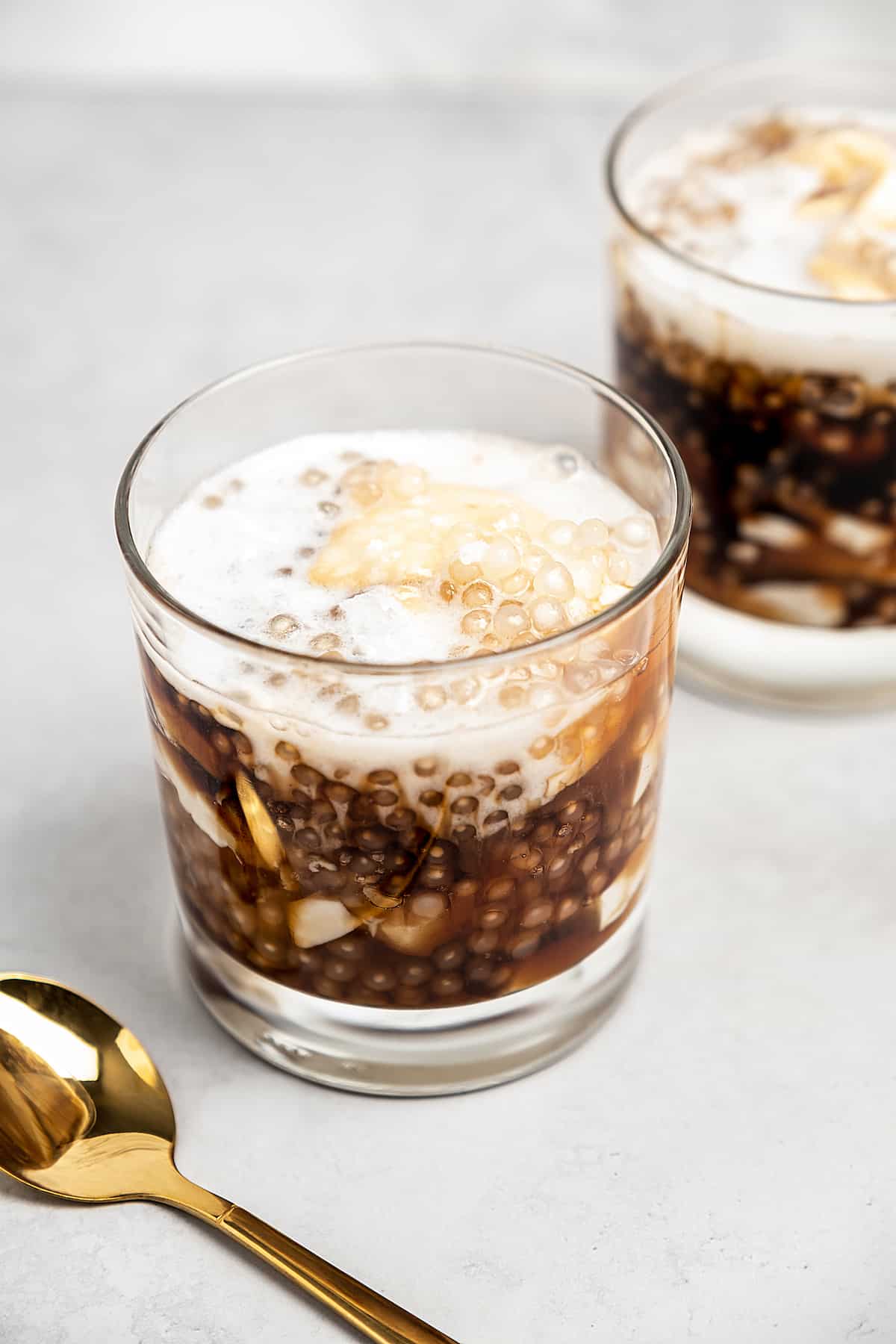 Two glasses of taho with gold spoon