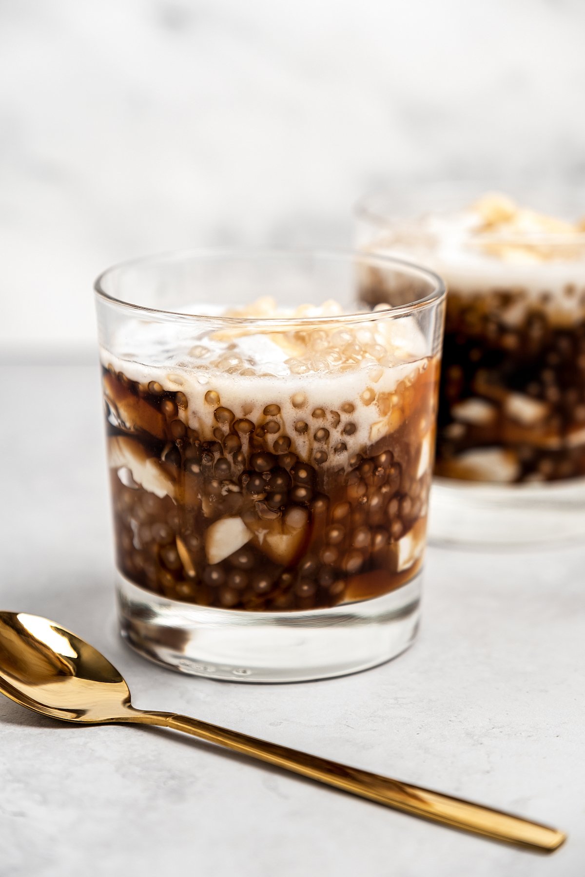 Two glasses of taho with gold spoon