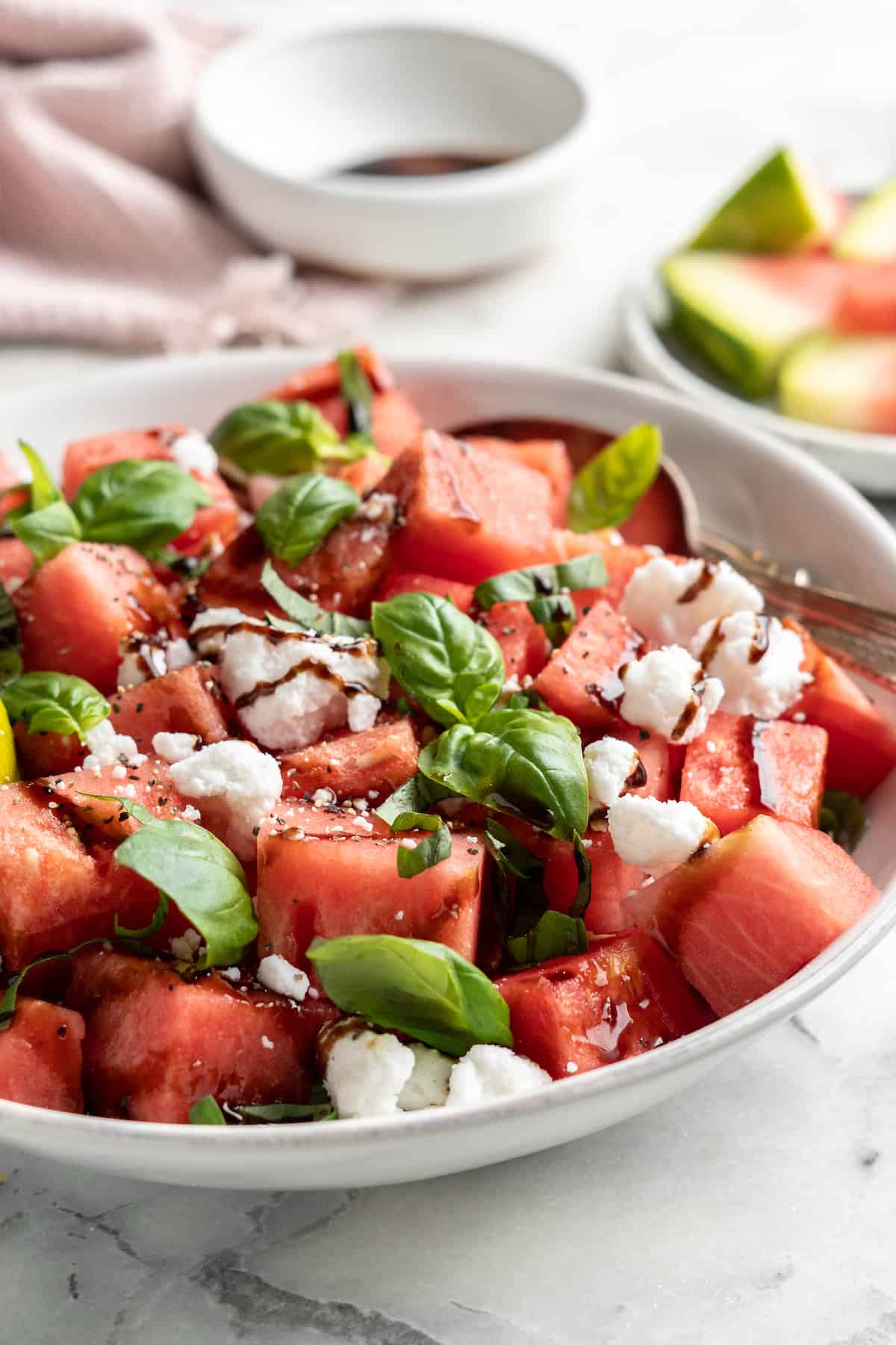 Vegan watermelon feta salad in bowl with spoon
