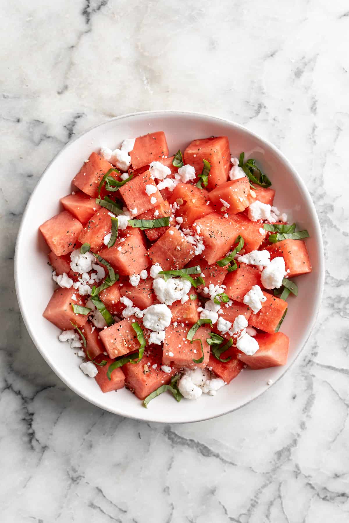 Overhead view of vegan watermelon feta salad before adding balsamic reduction