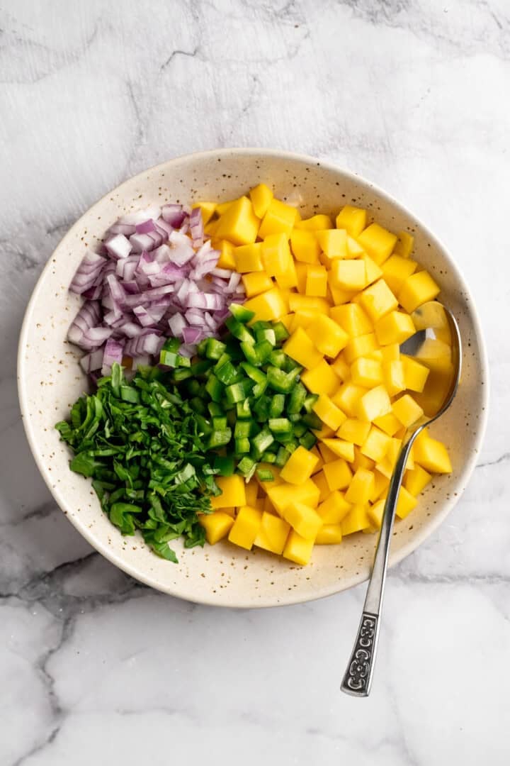 Ingredients for mango basil salsa in bowl before stirring. - 13