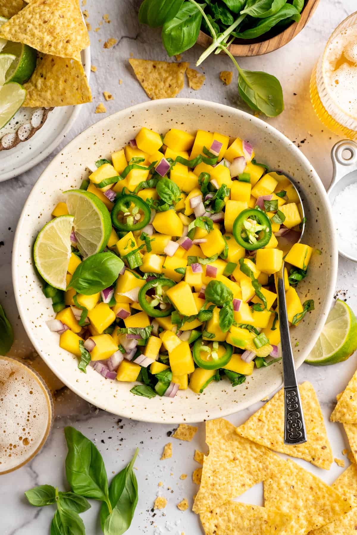 Mango basil salsa in bowl with spoon. - 11
