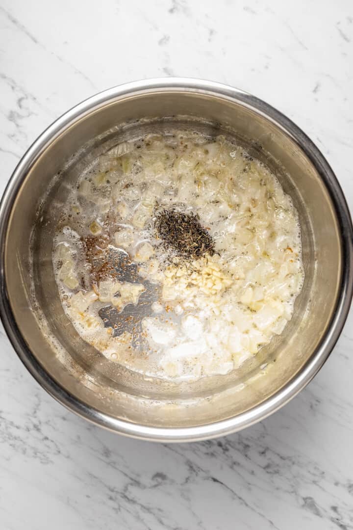 Overhead view of aromatics cooking in Instant Pot insert