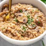 White bowl with vegan Instant Pot risotto and gold spoon