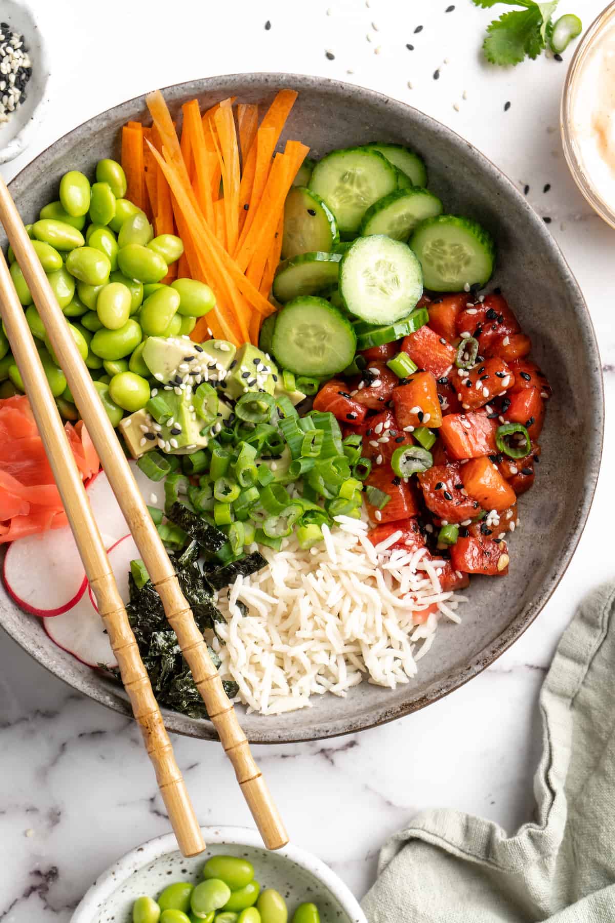 Overhead view of vegan poke bowl with chopsticks set on top