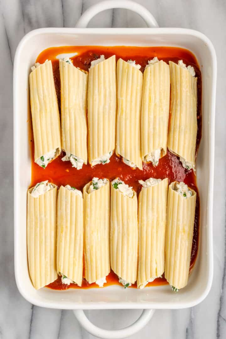 Overhead view of vegan manicotti in baking dish before adding sauce on top