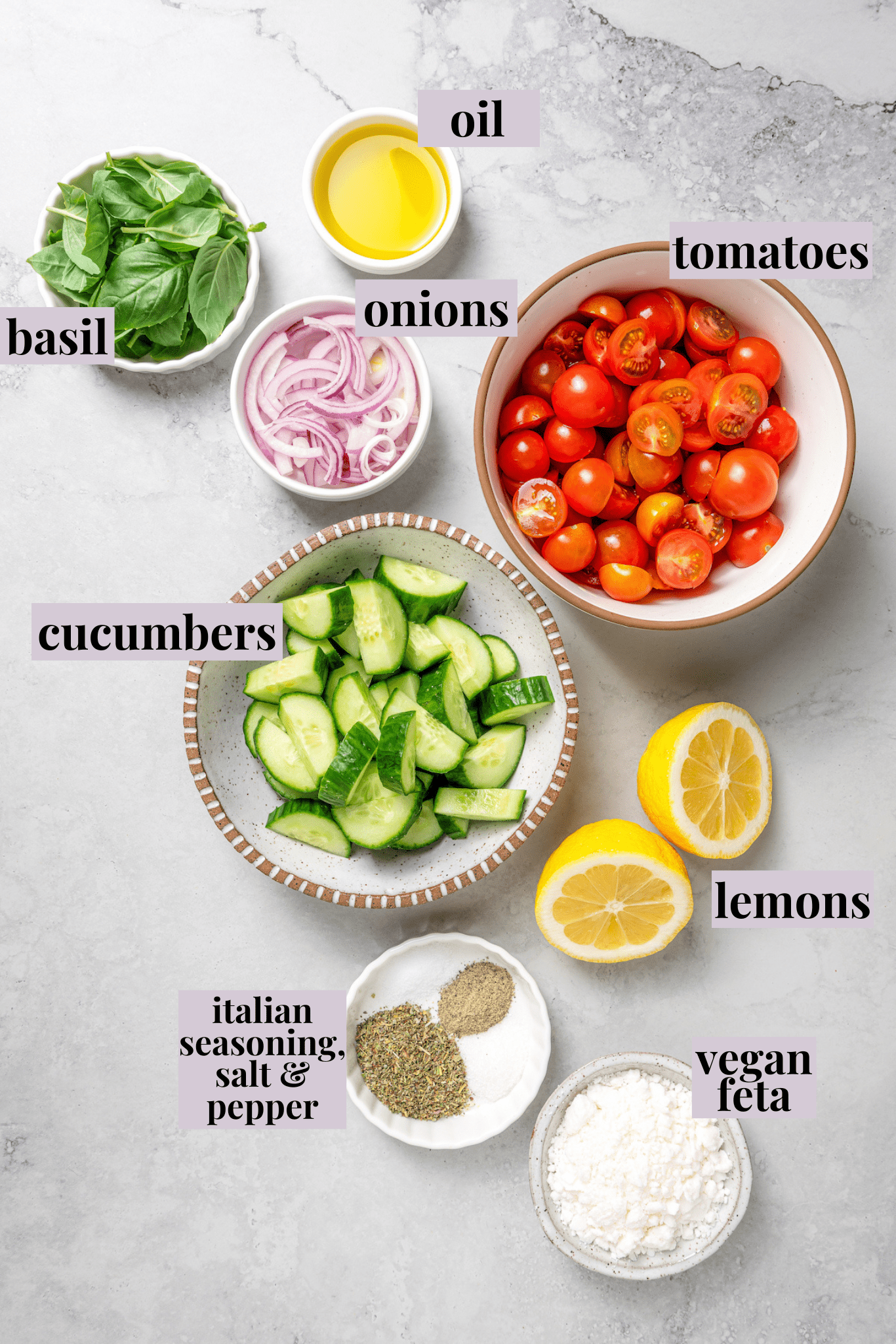 Overhead view of ingredients for cucumber and tomato salad with labels