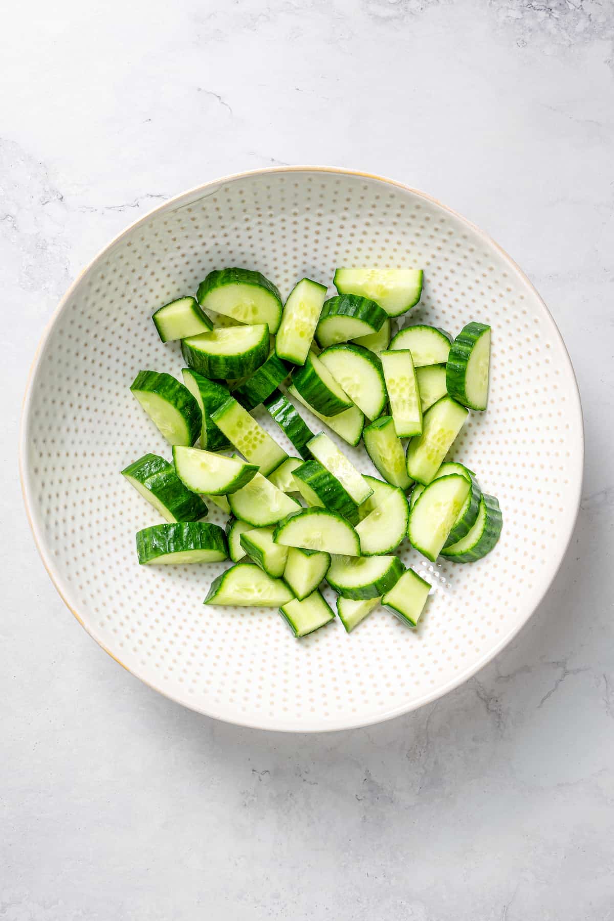 Overhead view of cucumber slices in bowl