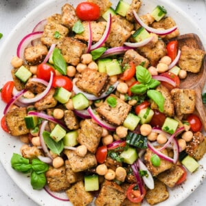 This Chickpea Panzanella Salad pairs crispy cubes of bread with chickpeas, veggies, and a zippy mustard balsamic vinaigrette. It’s a salad that eats like a meal!