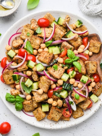 This Chickpea Panzanella Salad pairs crispy cubes of bread with chickpeas, veggies, and a zippy mustard balsamic vinaigrette. It’s a salad that eats like a meal!