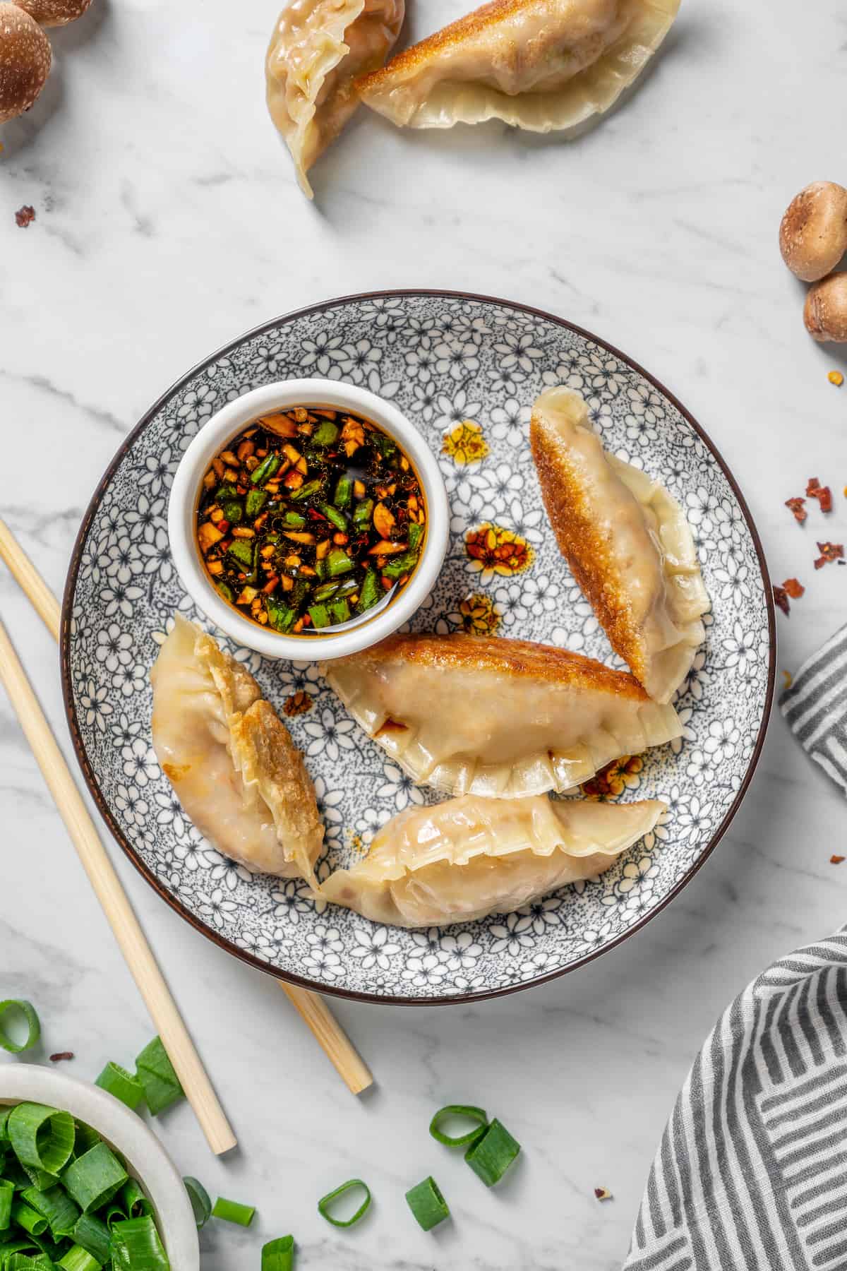 Overhead view of vegan dumplings on plate with dipping sauce