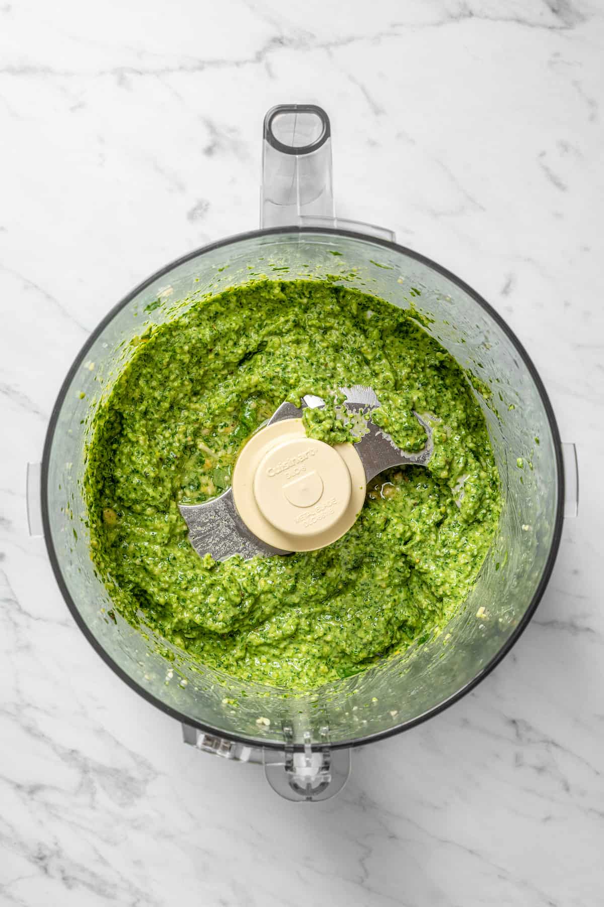 Overhead view of pesto in food processor