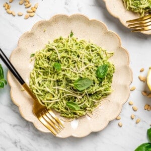 Overhead view of hearts of palm pasta on two plates with gold forks