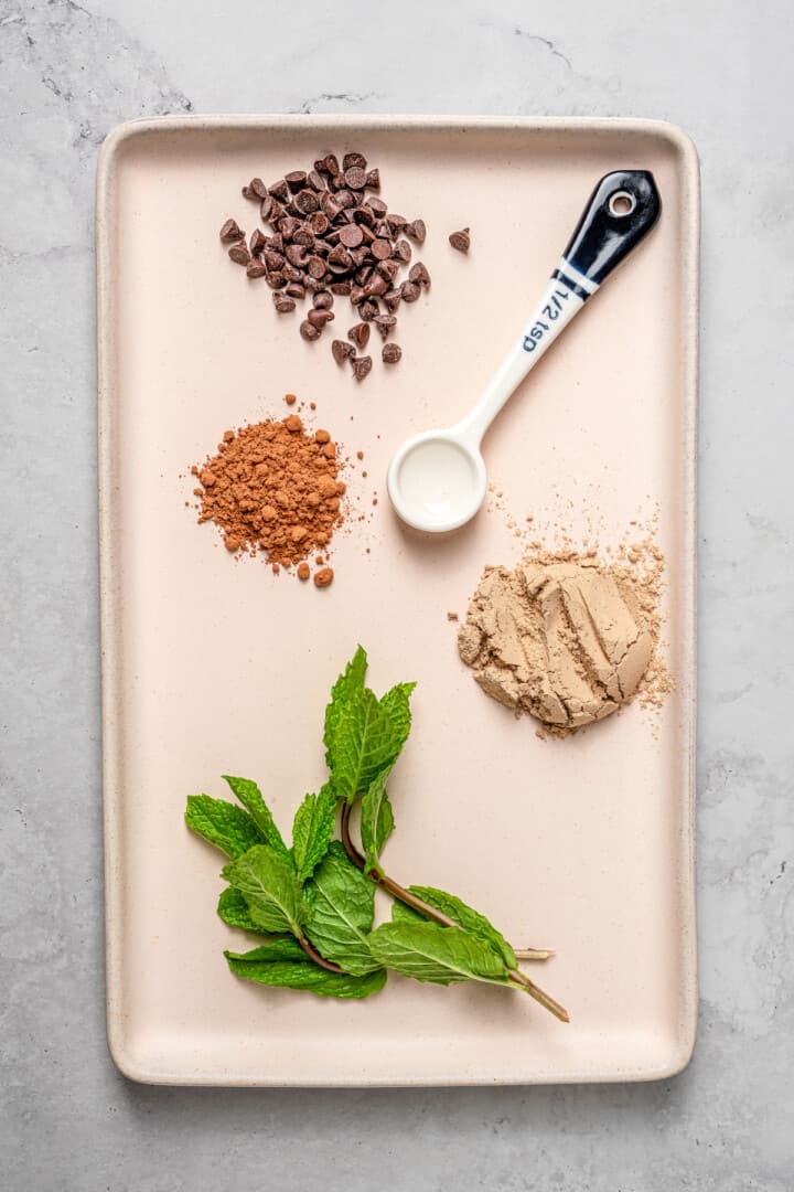 Overhead view of ingredients for chocolate mint high-protein overnight oats