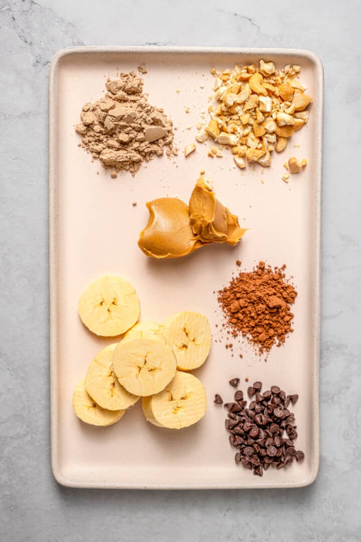 Overhead view of ingredients for chocolate peanut butter high-protein overnight oats