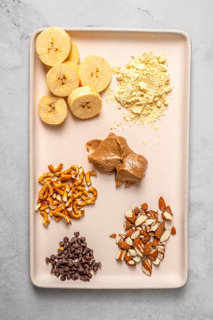 Overhead view of ingredients for almond butter pretzel high-protein overnight oats
