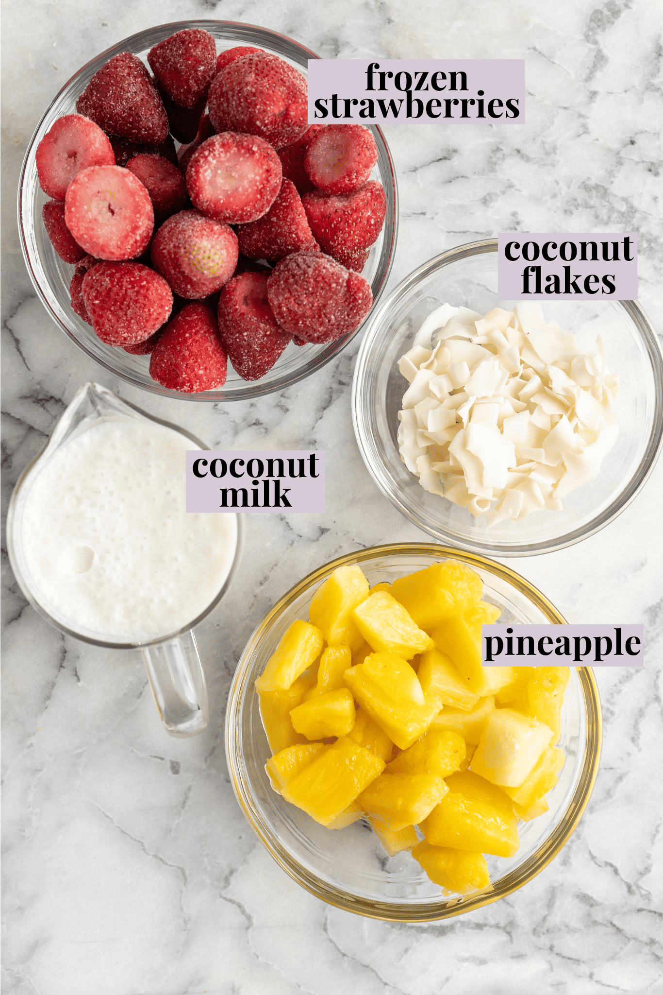 Overhead view of ingredients for strawberry pineapple smoothie