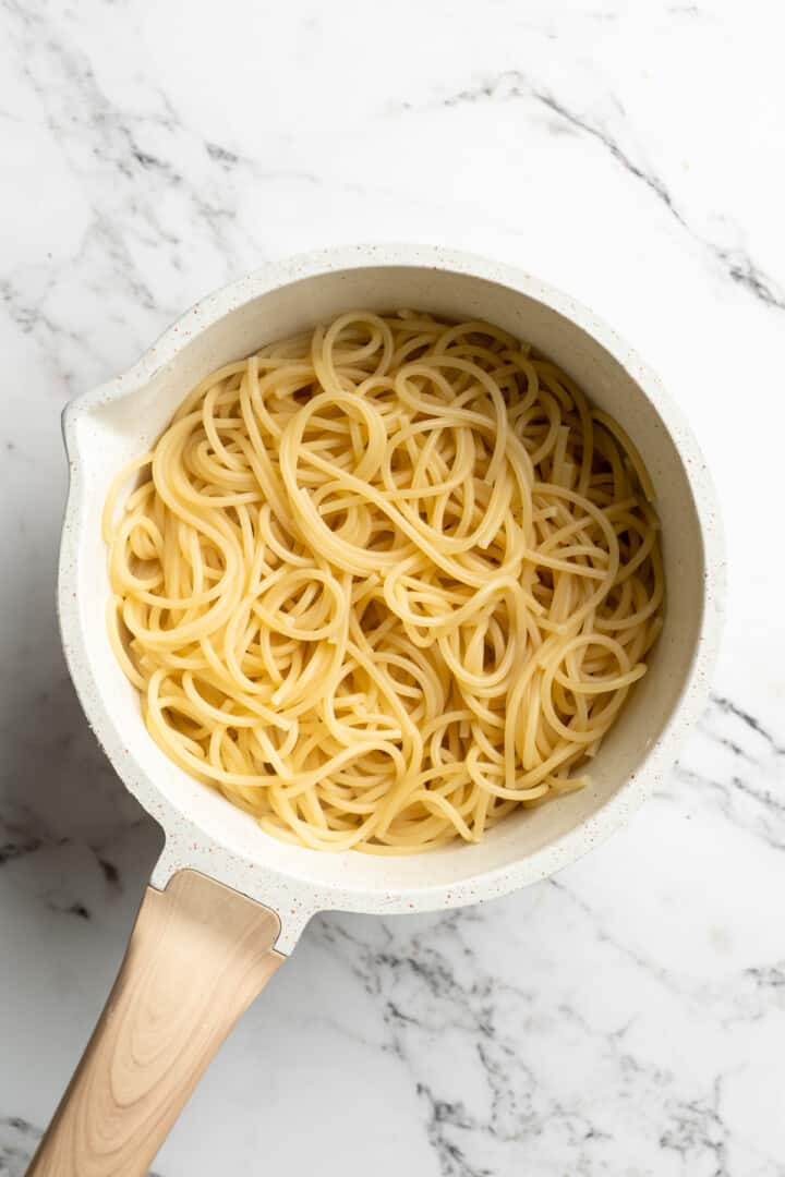 Overhead view of cooked spaghetti in pan