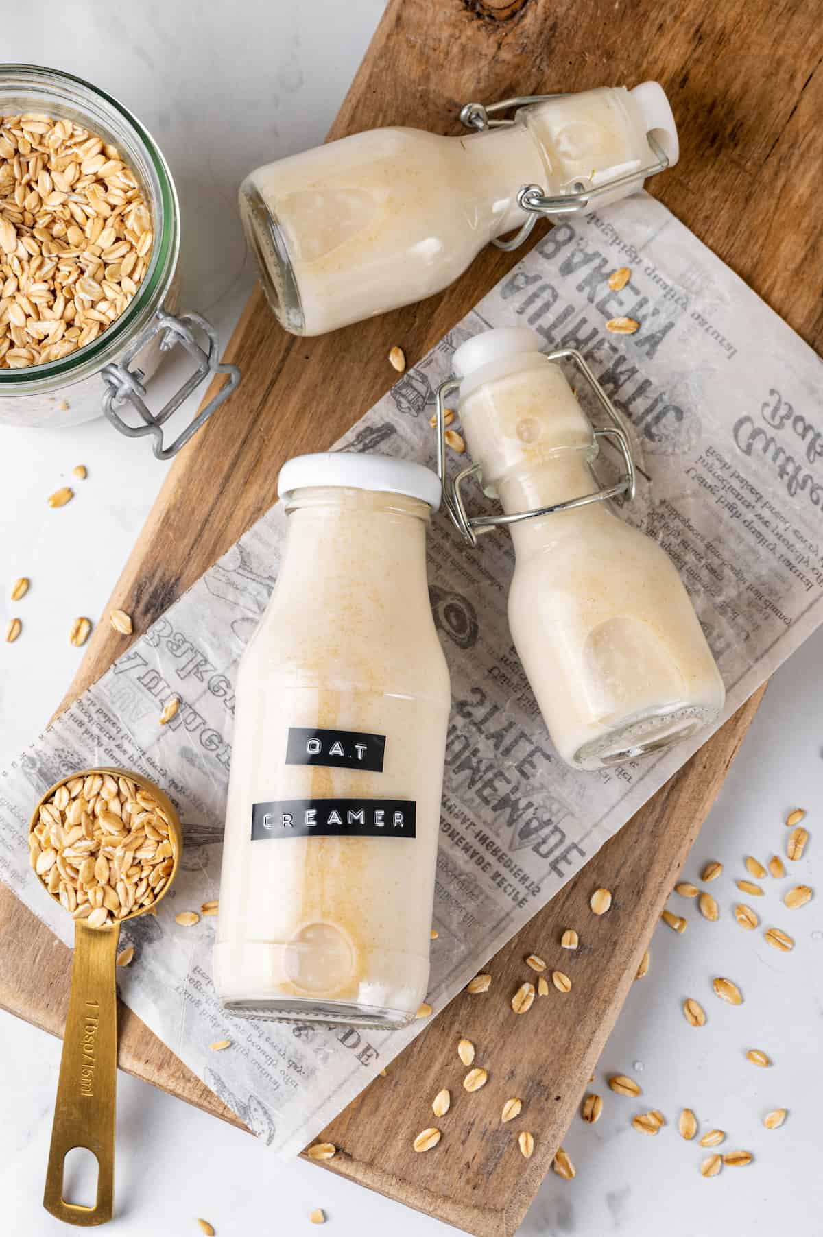 Overhead view of homemade oat milk creamer in bottles