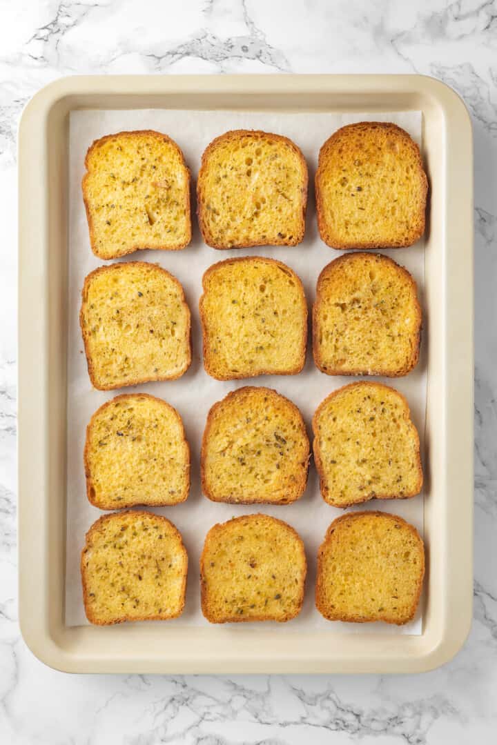 Overhead view of 12 slices of Texas toast on sheet pan