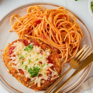 Overhead view of chicken parmesan on plate with spaghetti