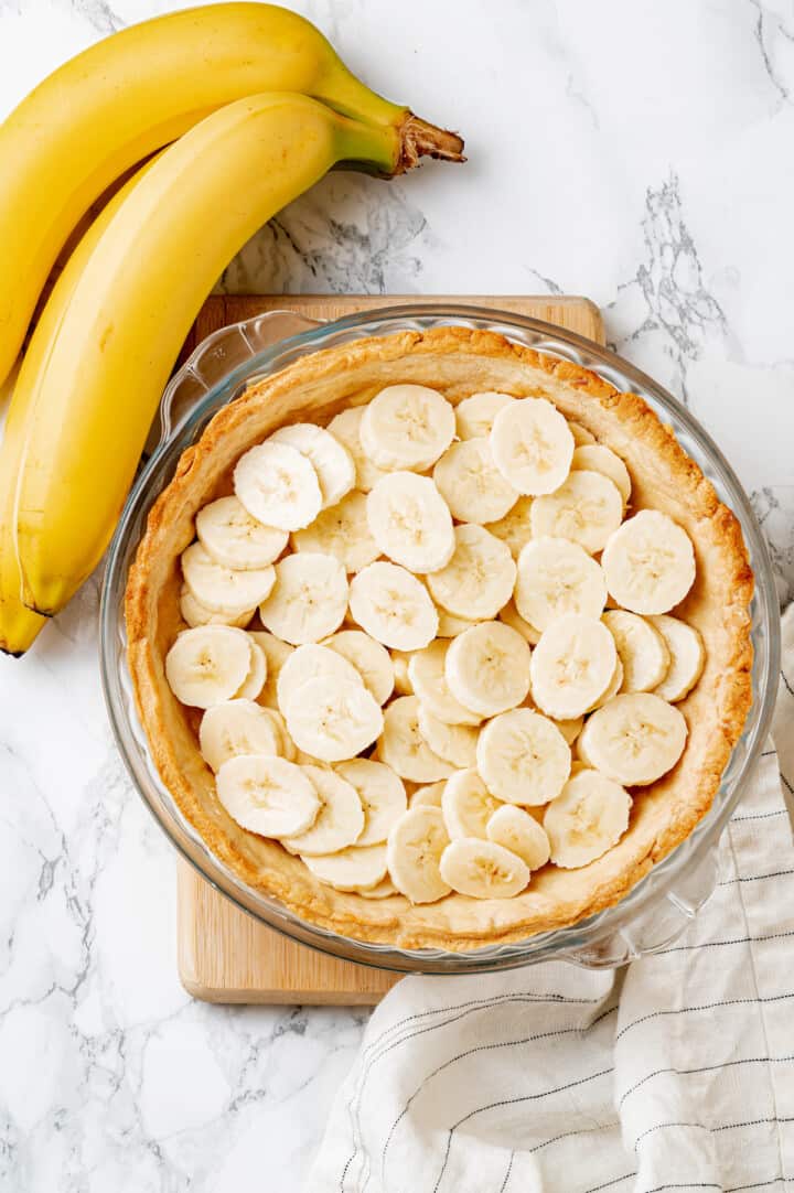 Overhead view of bananas arranged in baked pie crust