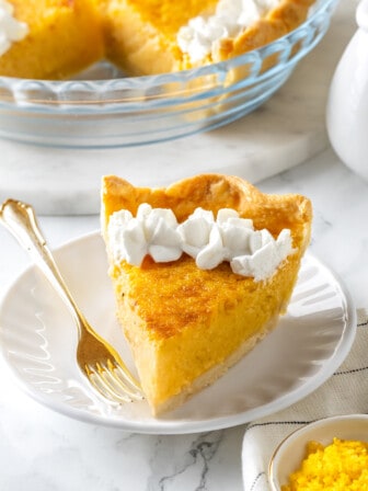 Slice of buttermilk pie on plate with fork